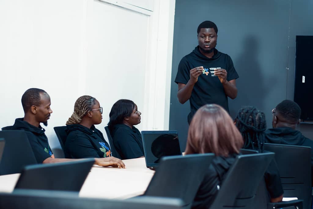 TFT-TSH facilitator leading a Beyond the Classroom coaching session with young professionals.