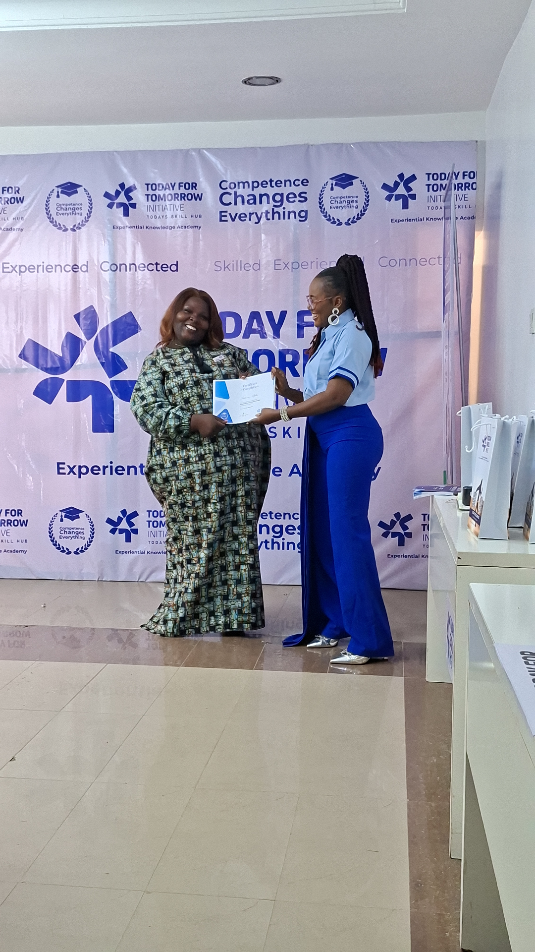 Graduate receiving Certificate of Completion on stage