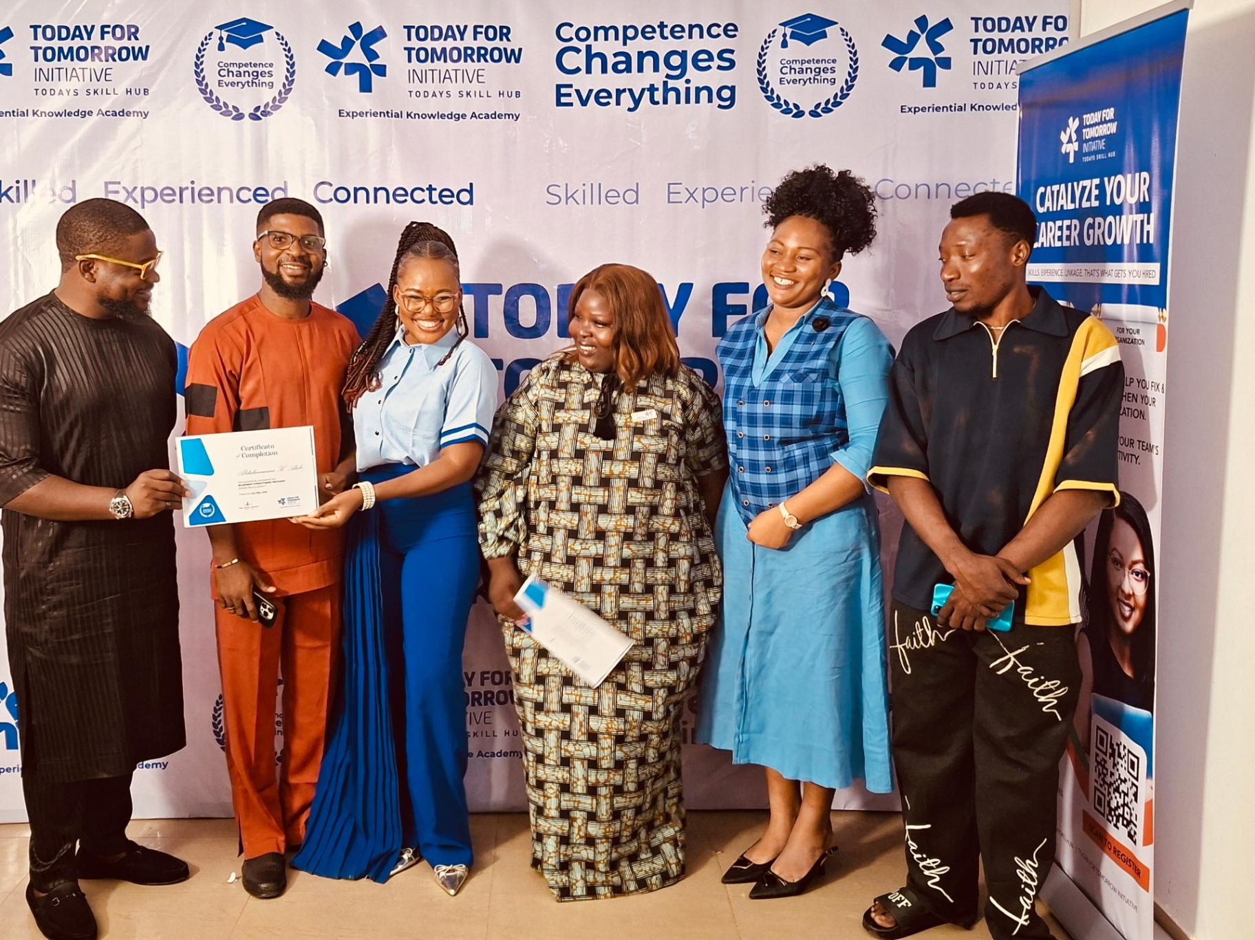 Graduates and facilitators pose after certificate presentation